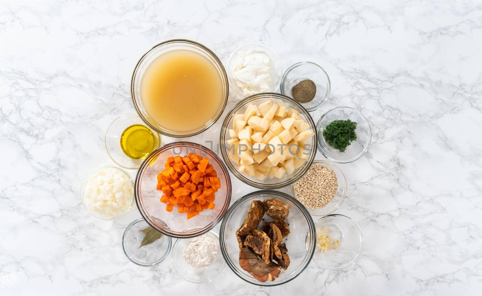 Flat lay. Measured ingredients in a glass mixing bowl to prepare creamy wild mushroom soup.