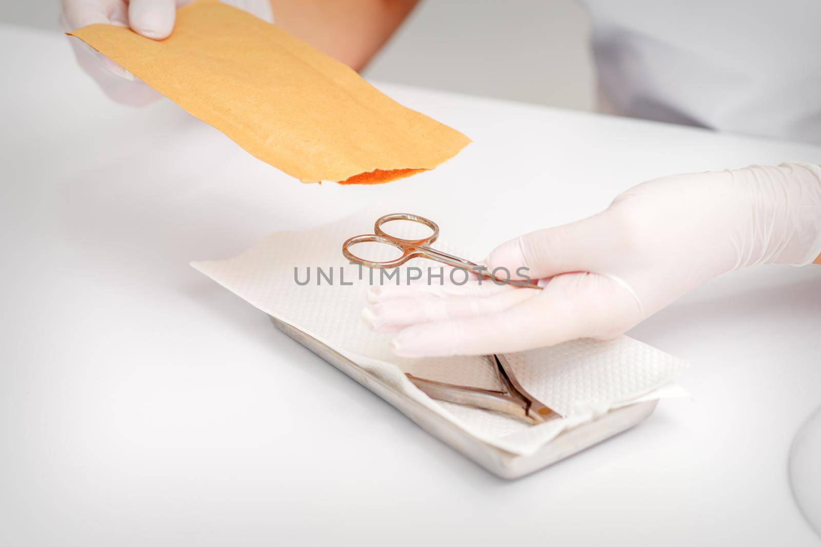 Master of manicure sterilizing manicure scissors. Disinfection of manicure tools