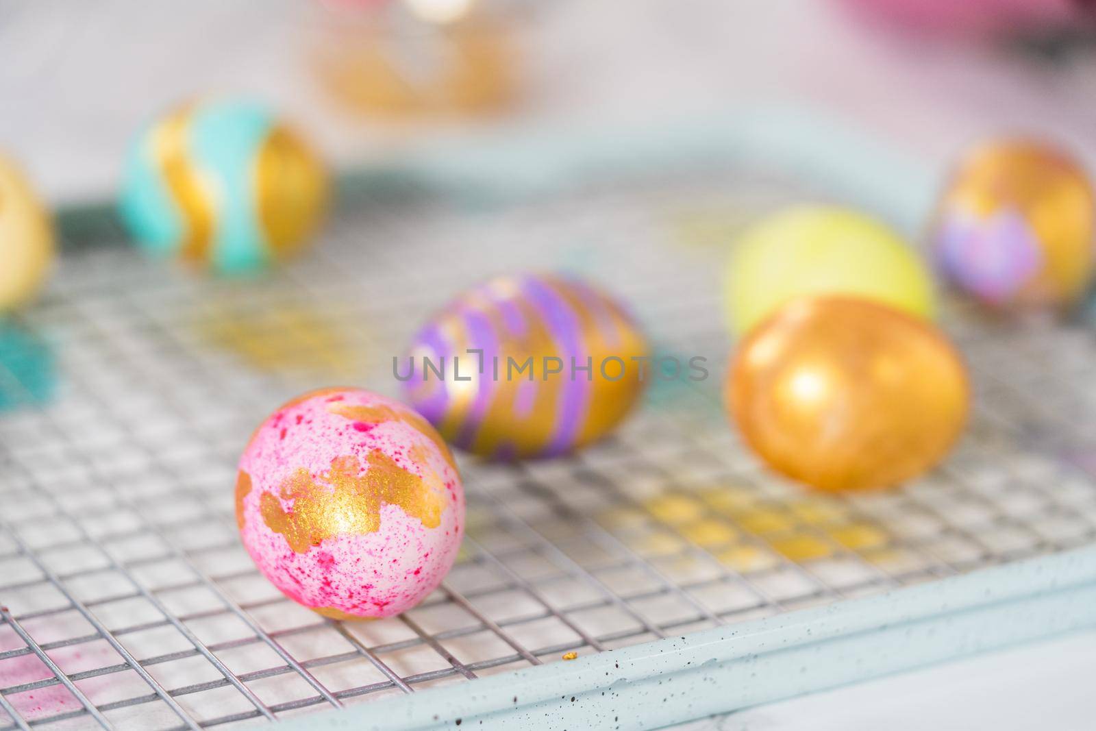 Easter egg coloring. Painting Easter eggs with gold luster.