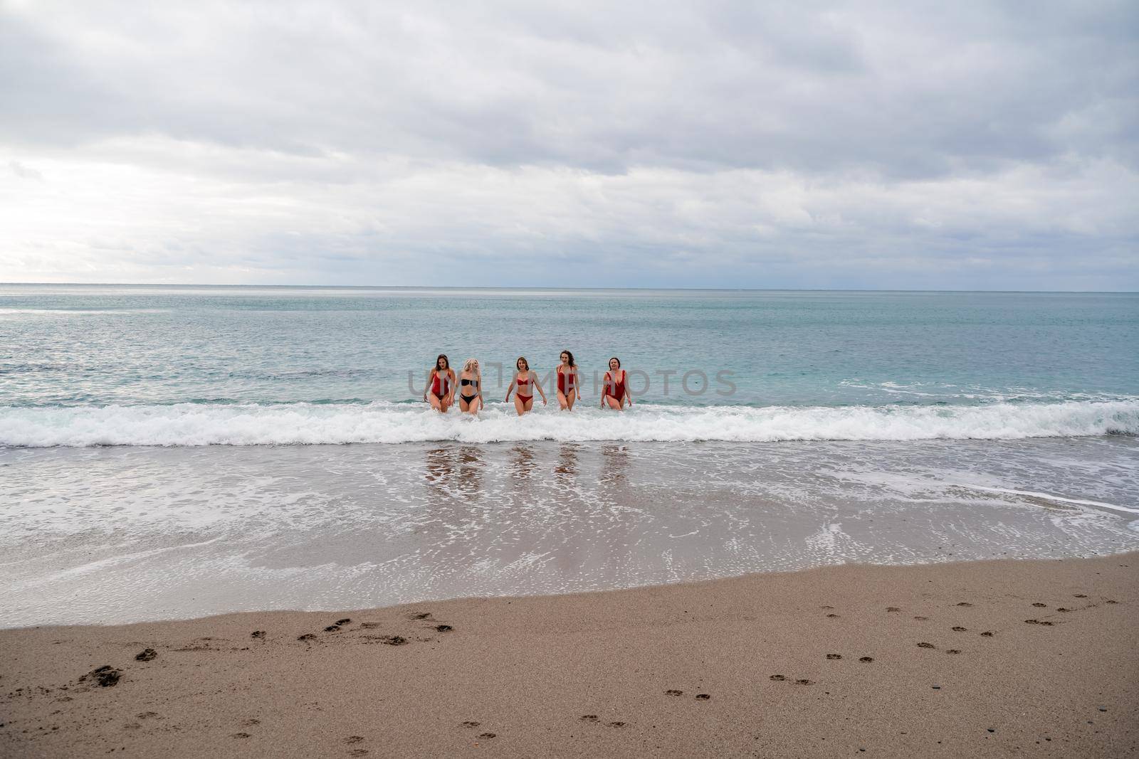 Big happy family or group of five friends is having fun against sunset beach. Beach holidays concept. by Matiunina