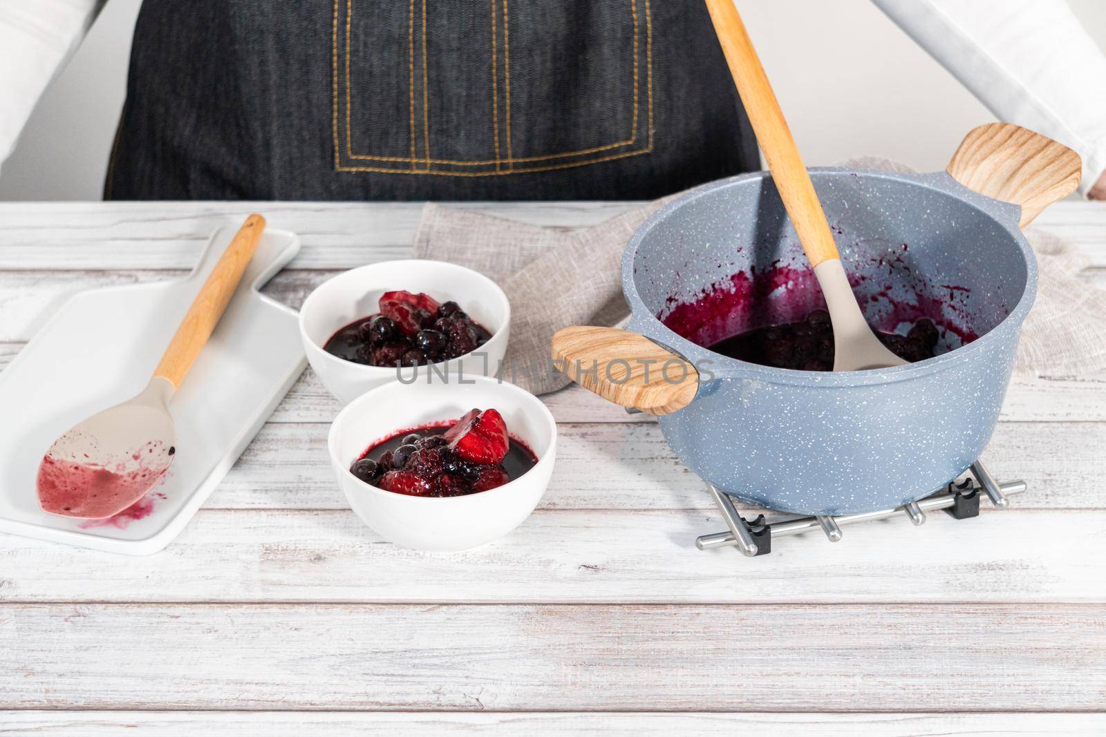 Preparing mixed berry compote from frozen berries in a nonstick cooking pot.