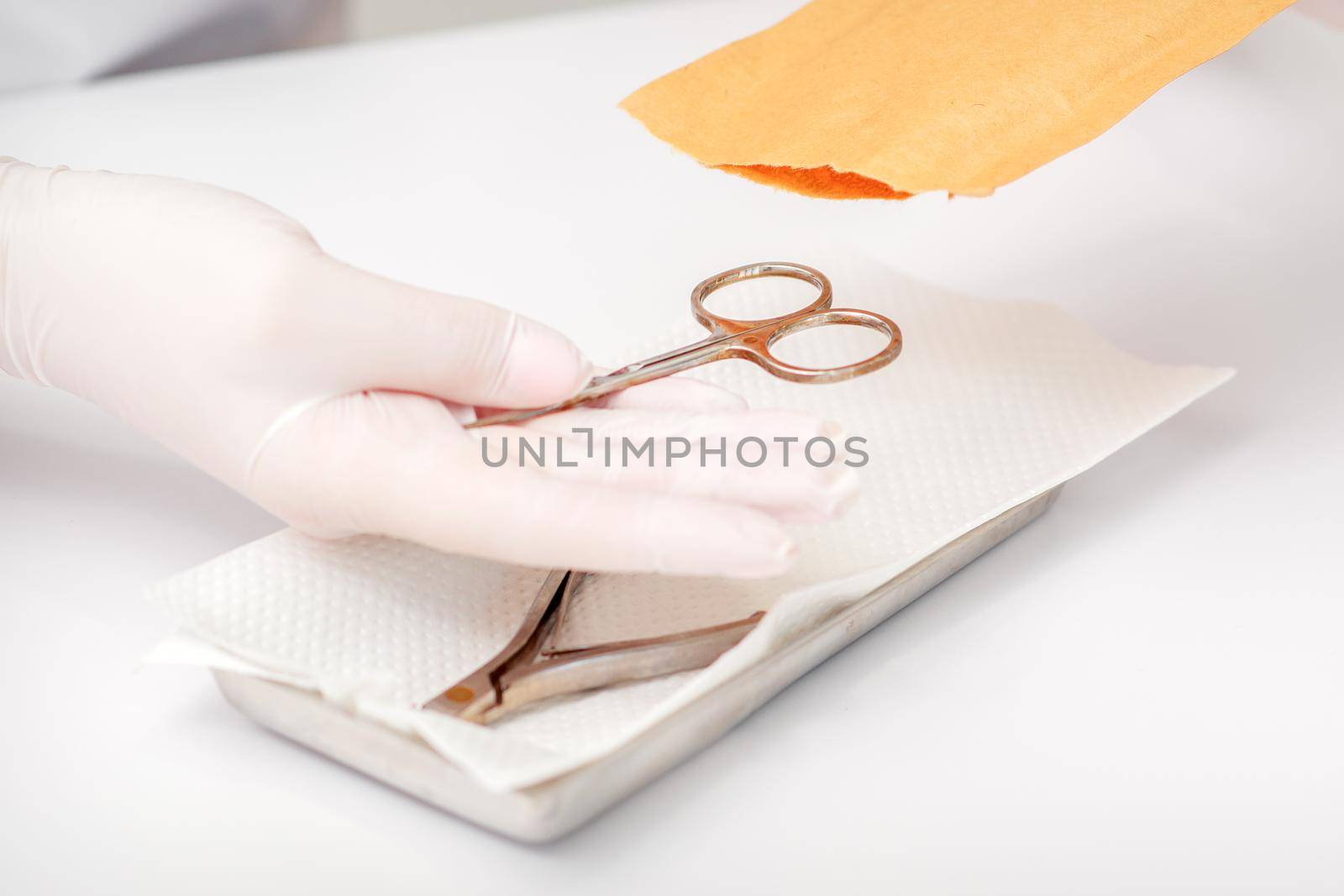 Master of manicure sterilizing manicure scissors. Disinfection of manicure tools