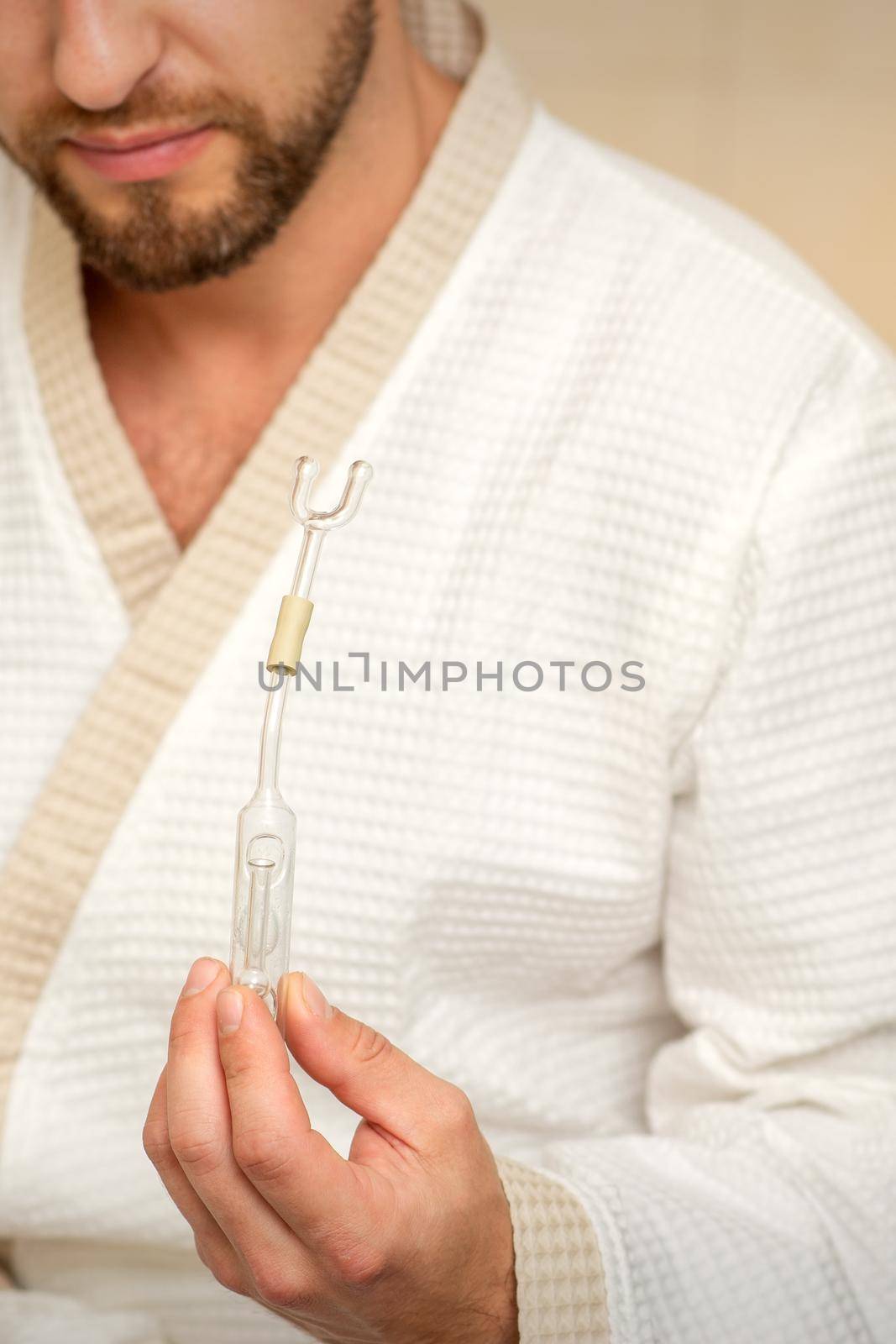 Young caucasian man receiving nasal inhalation Maholda with essential oil in the nose at a hospital