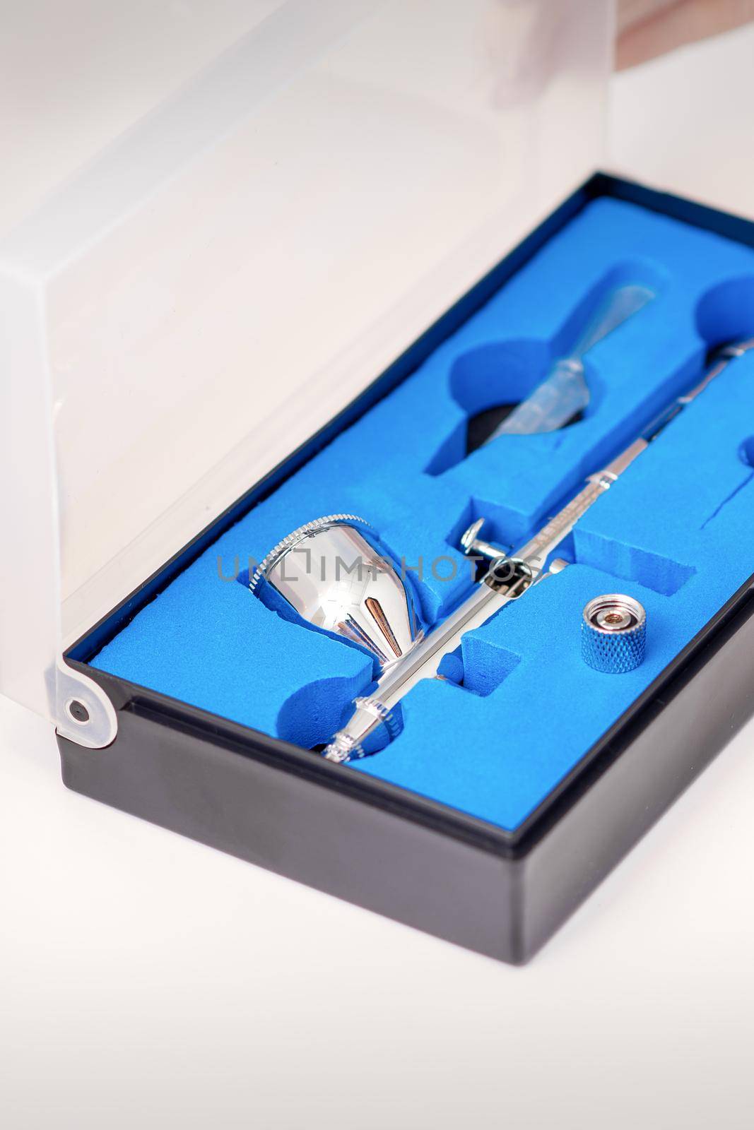Close up of new clean airbrush tool in the blue box