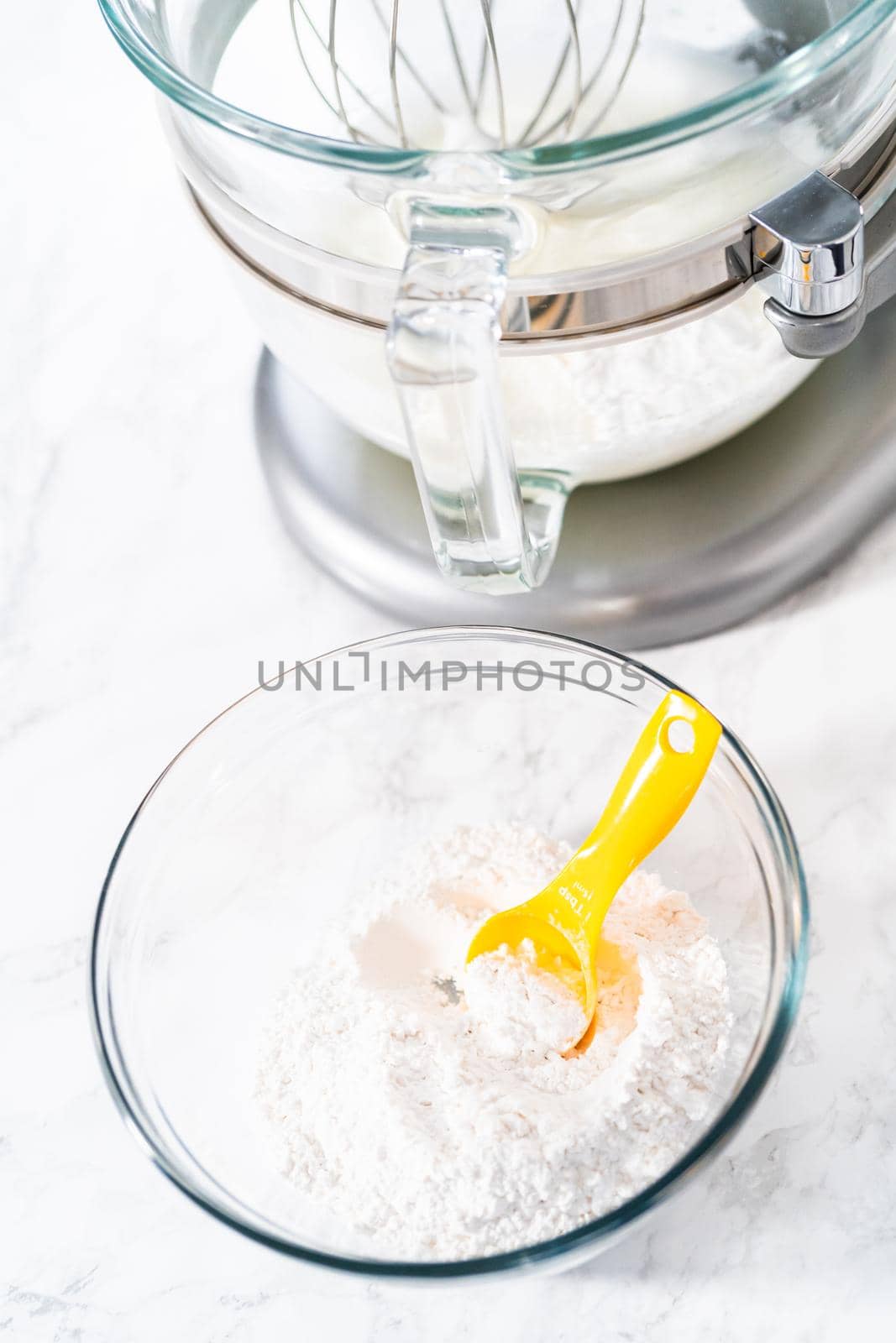 Mixing ingredients in kitchen electric mixer to bake meringue cookies.