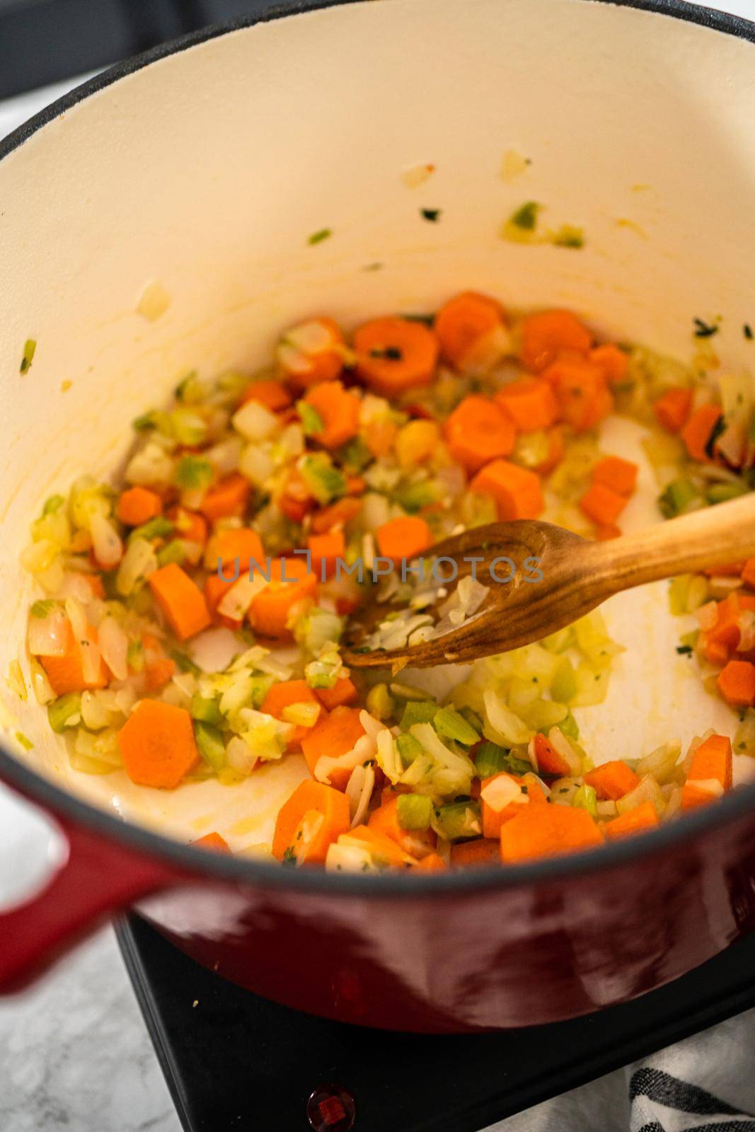 Cooking chicken noodle soup with kluski noodles in an enameled dutch oven.