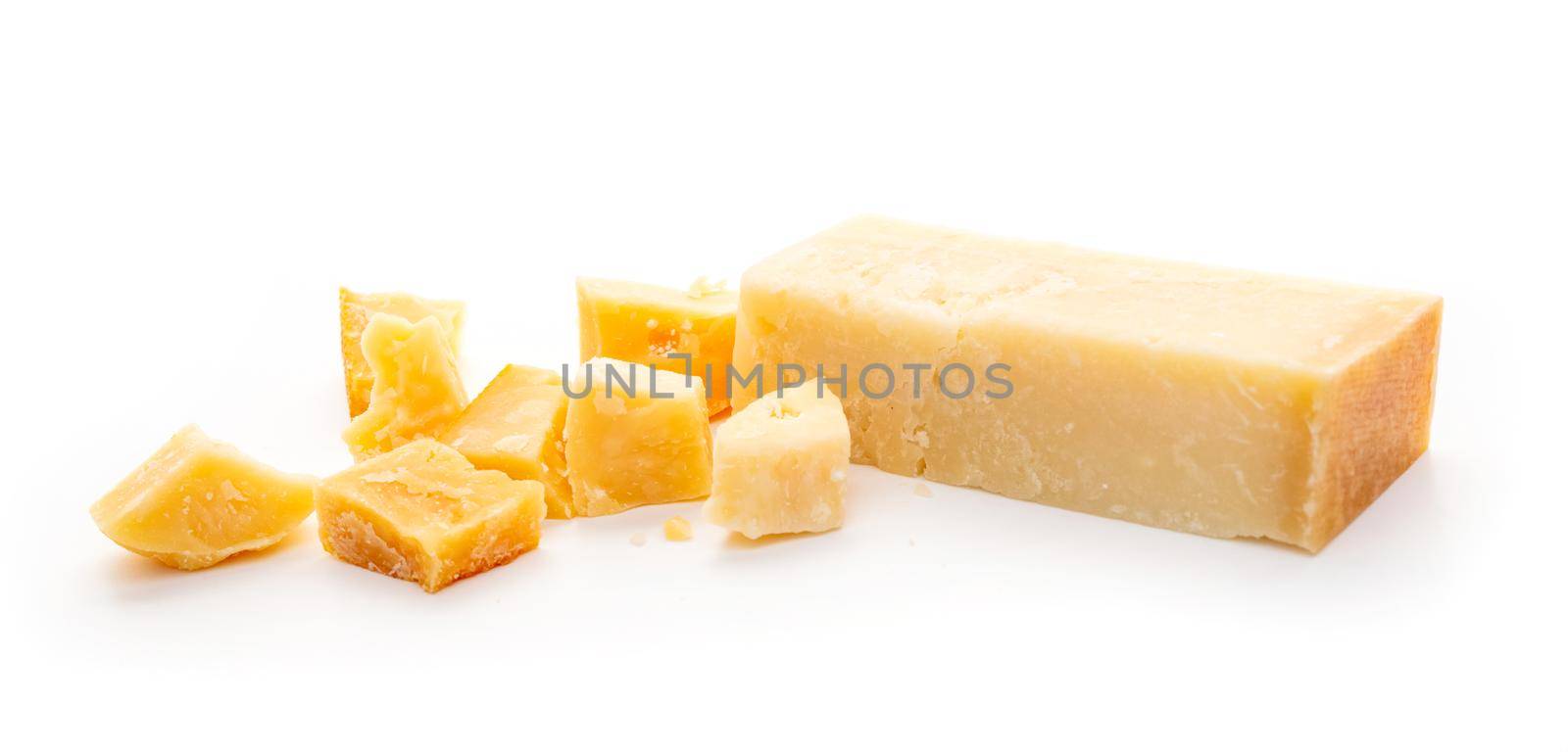 Piece of parmesan cheese and grater on white background