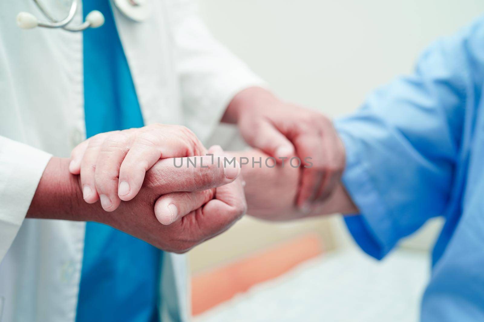 Doctor holding hands Asian elderly woman patient, help and care in hospital.