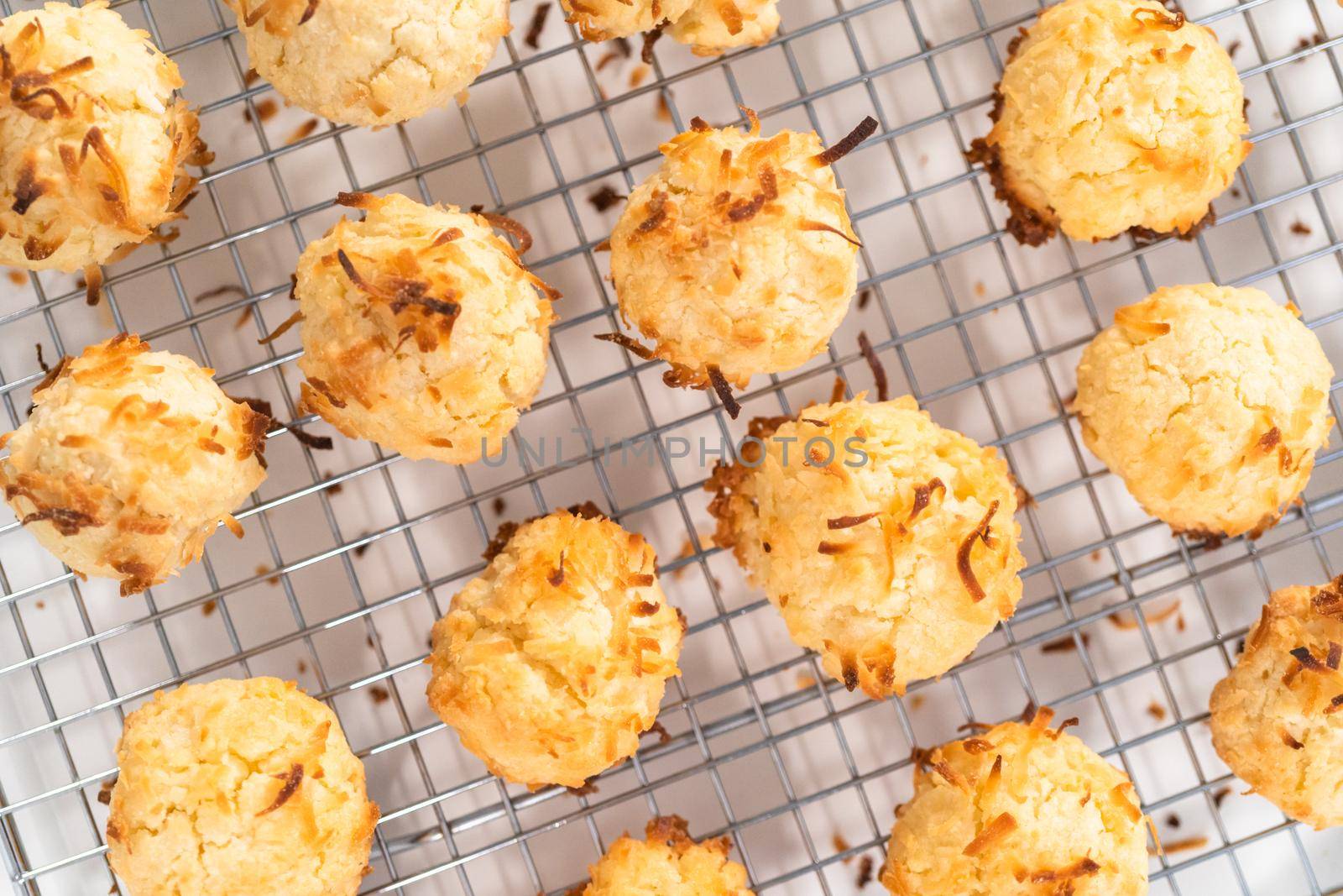 Cooling freshly baked coconut cookies on the kitchen drying rack.