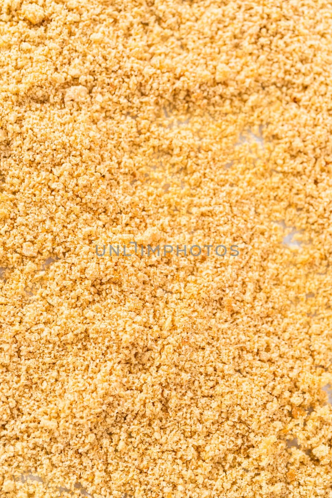 Cooling freshly dried bread crumbs on a baking sheet lined with parchment paper.