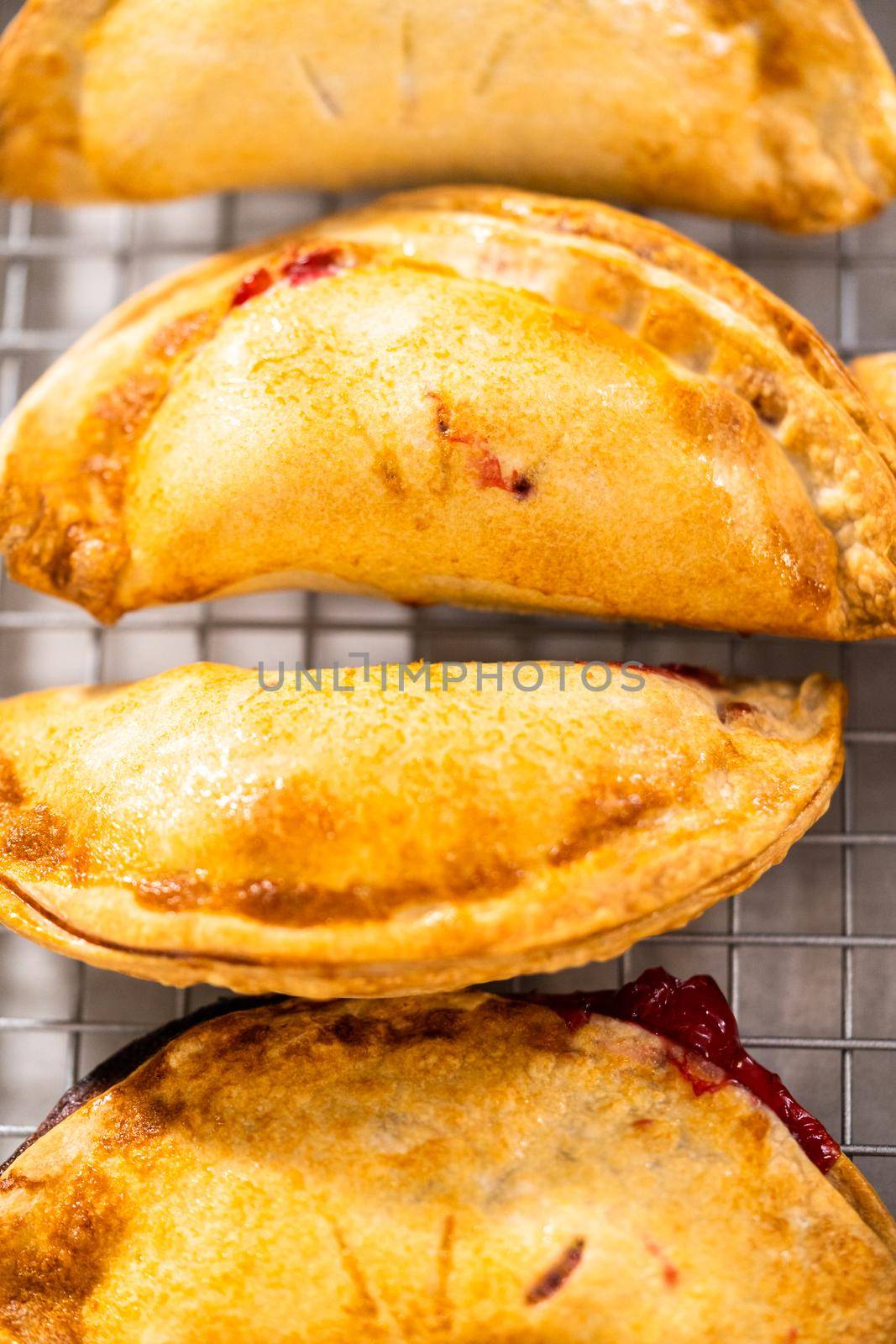 Freshly baked sweet cherry empanadas in the air fryer on the kitchen counter.