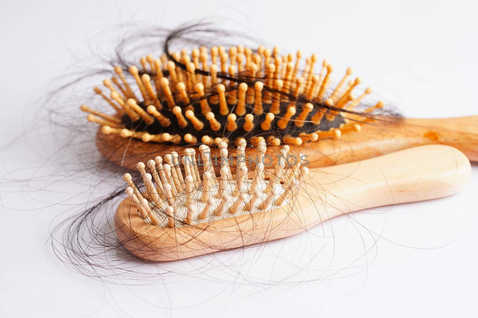 Hair loss fall with comb brush isolated on white background.