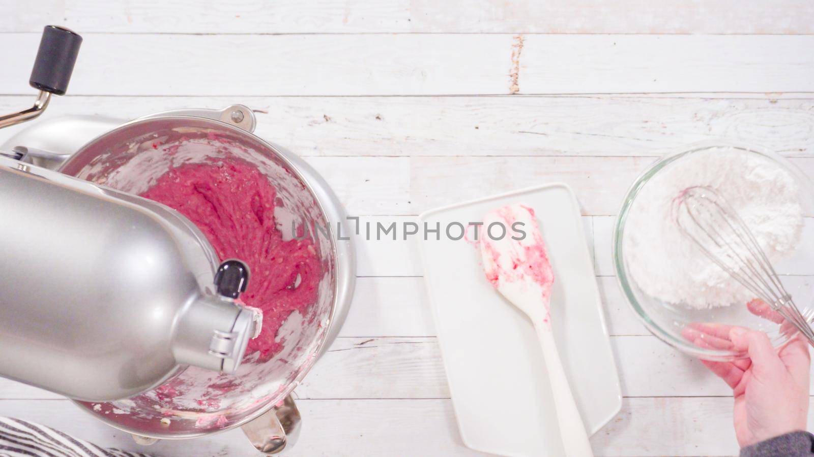Flat lay. Preparing raspberry cream cheese buttercream in kitchen mixer for bake chocolate raspberry cupcakes.