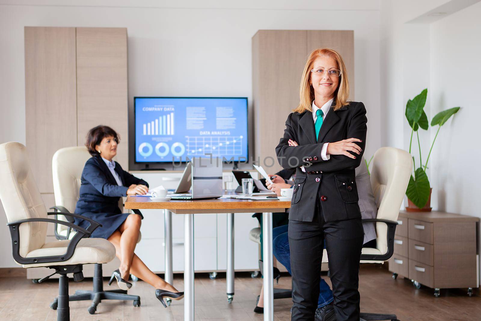 Happy beautiful bussines woman in conference room. Successful woman.