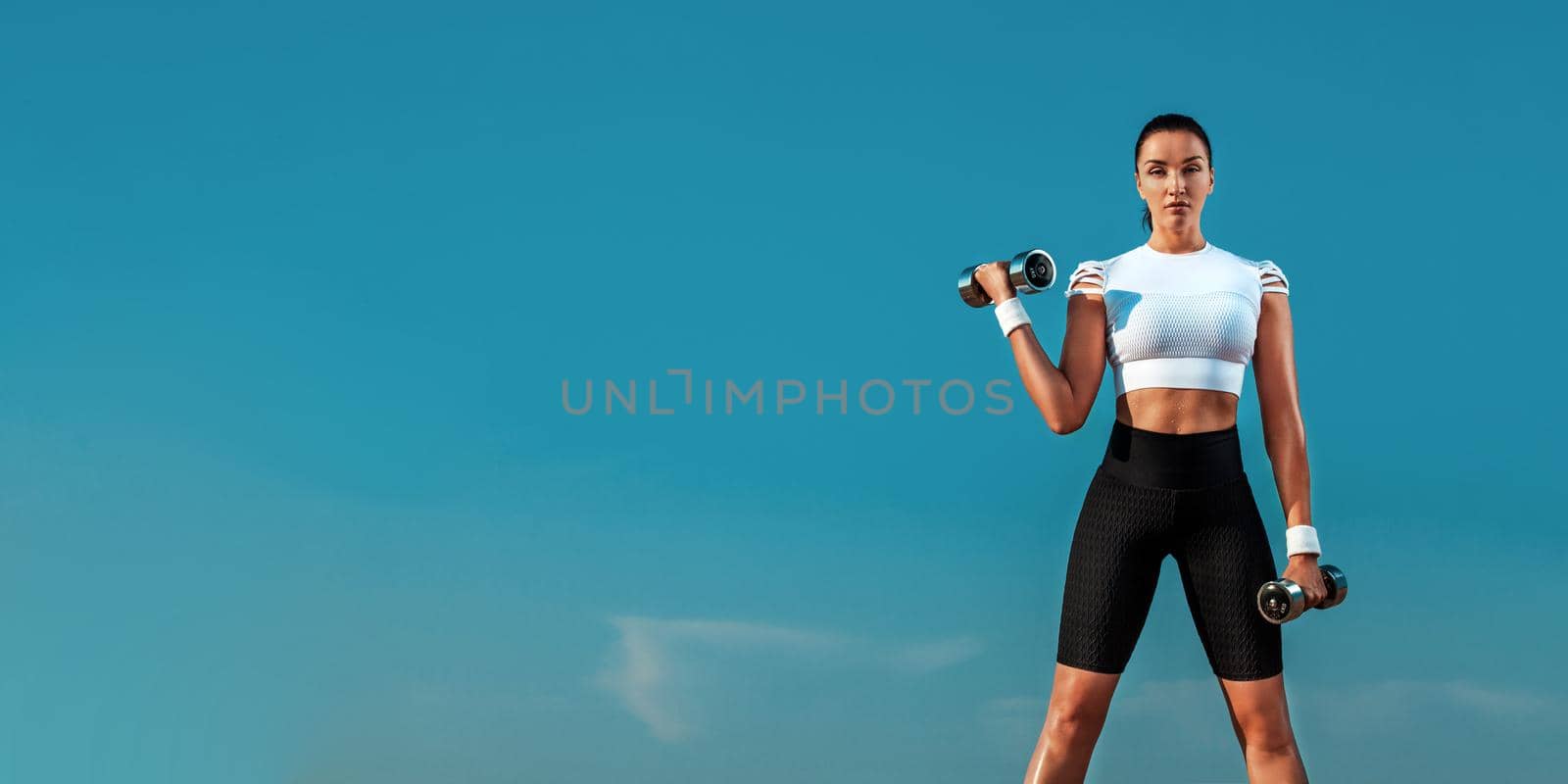 Banner picture for fitness website. Fit woman works on weight loss and fat burning outdoors. by MikeOrlov