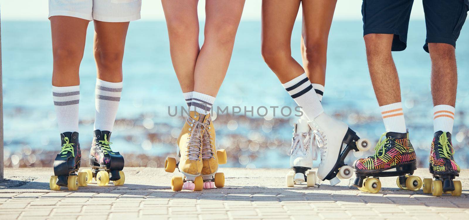 Roller skates, friends and beach with a group of people on the promenade at the beach with the sea in the background. Summer, fun and lifestyle with a skaters skating outside during a sunny day by YuriArcurs