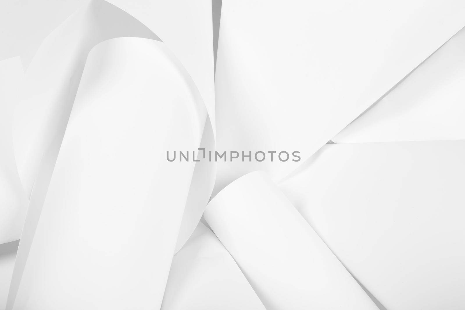 White sheets of office paper are twisted and scattered. Paper white abstract background.