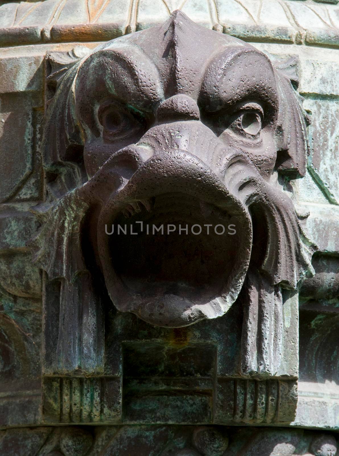 Demonic statue face made of metal on a street lamp. Szechenyi Bath Budapest, Hungary.