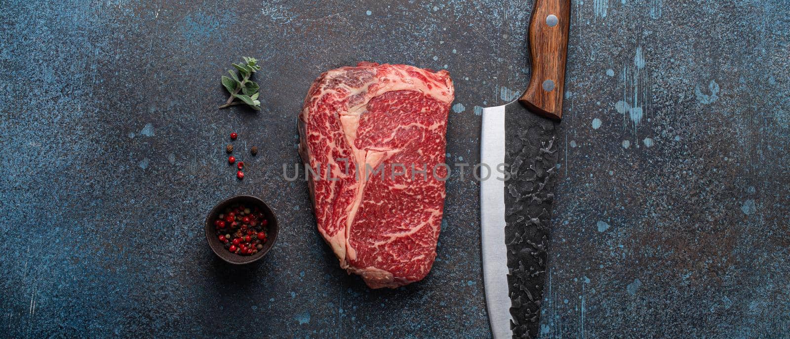 Raw meat beef marbled prime cut steak Ribeye on rustic concrete kitchen table by its_al_dente