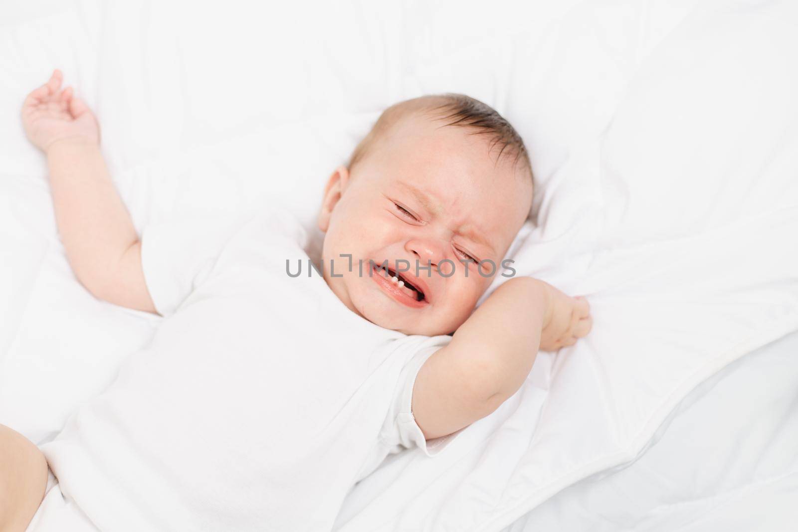 The baby is crying in his crib . The baby 's teeth are teething . Colic in babies . Hungry baby . by alenka2194