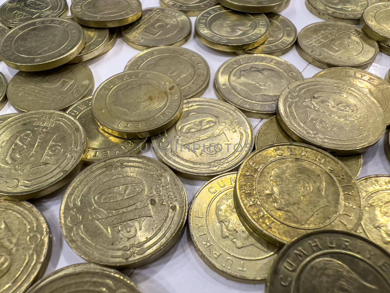 Turkish coins of 10 kurus and 5 kurus standing in a pile on a white background