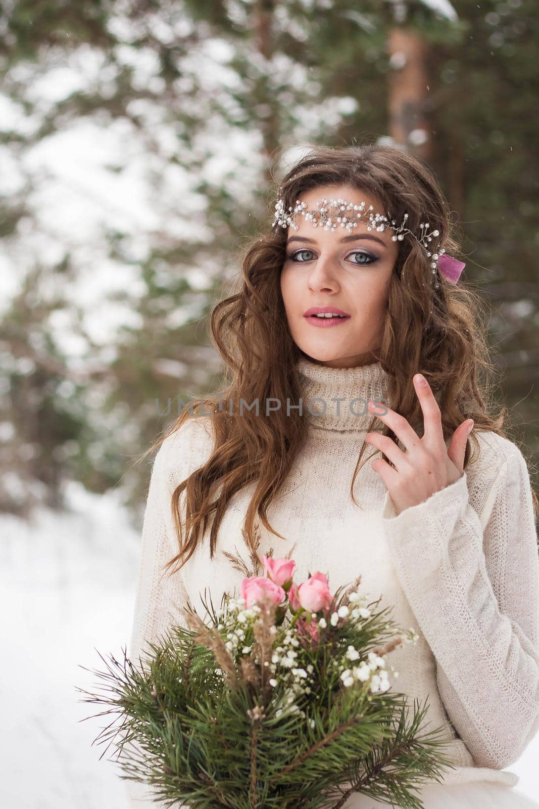 Beautiful bride in a white dress with a bouquet in a snow-covered winter forest. Portrait of the bride in nature. by Annu1tochka