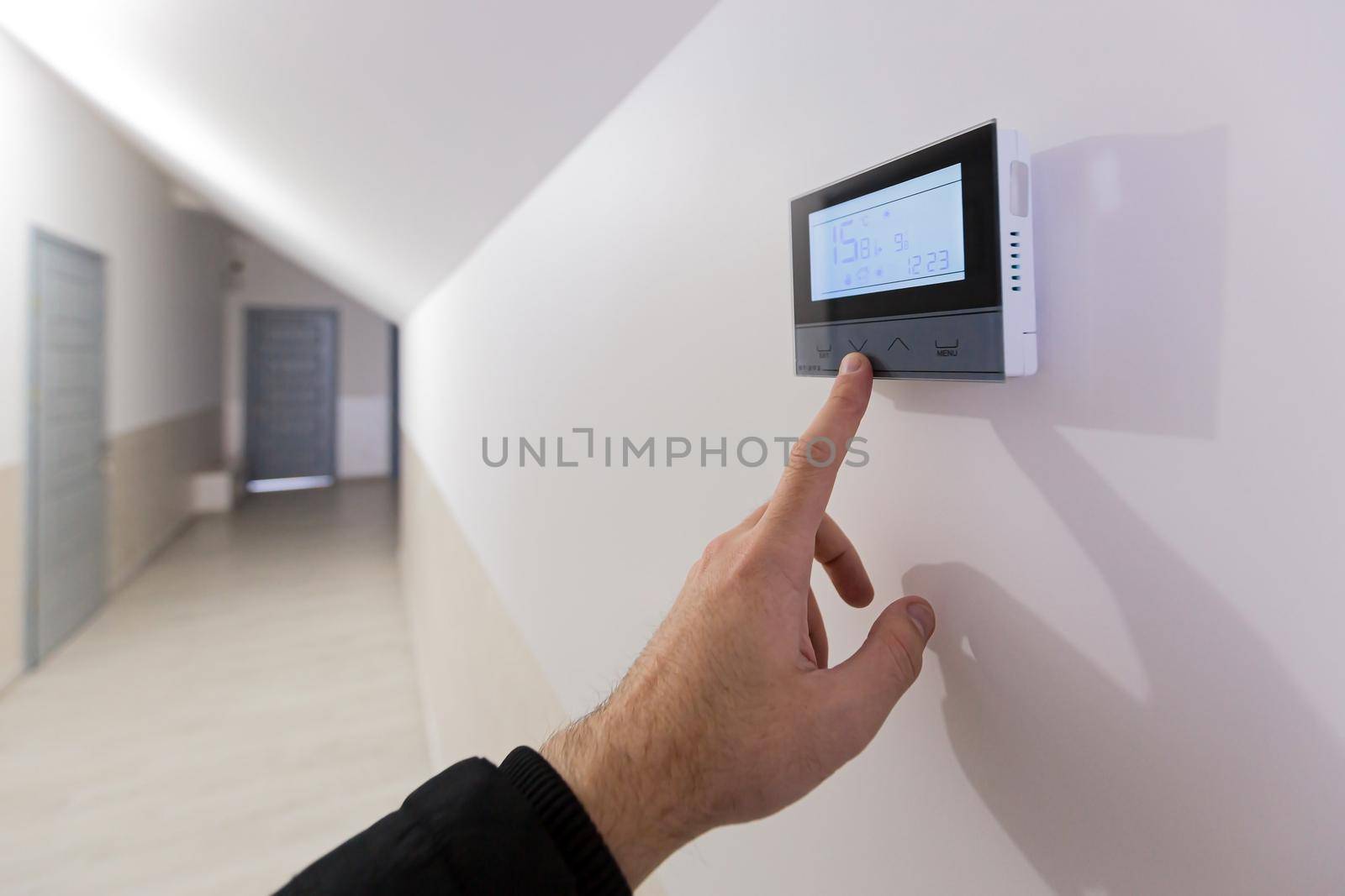 The air conditioning and heating control panel for the apartment and office is located on a white wall