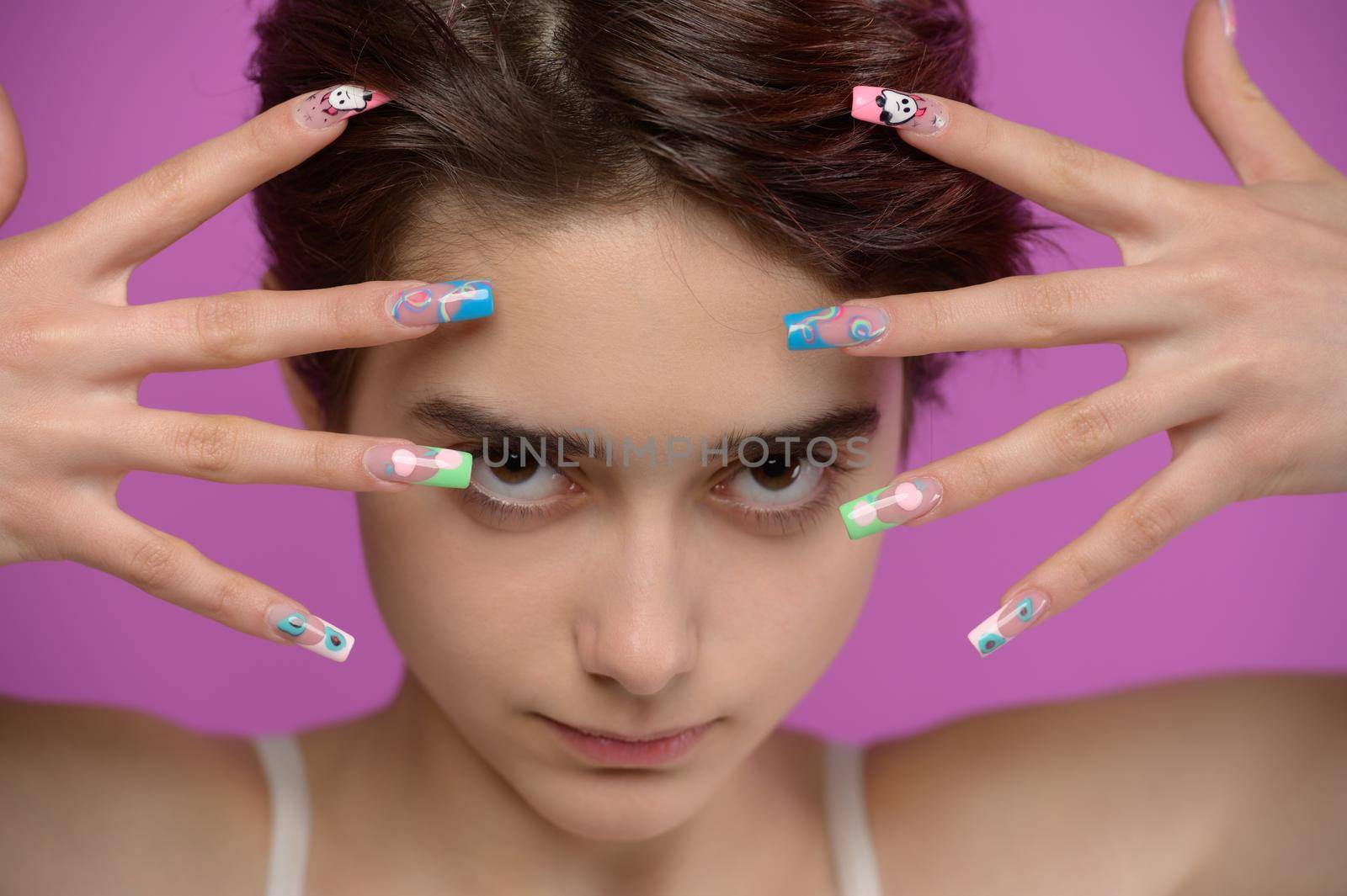 Pretty girl with short haircut and extravagant nail art by starush