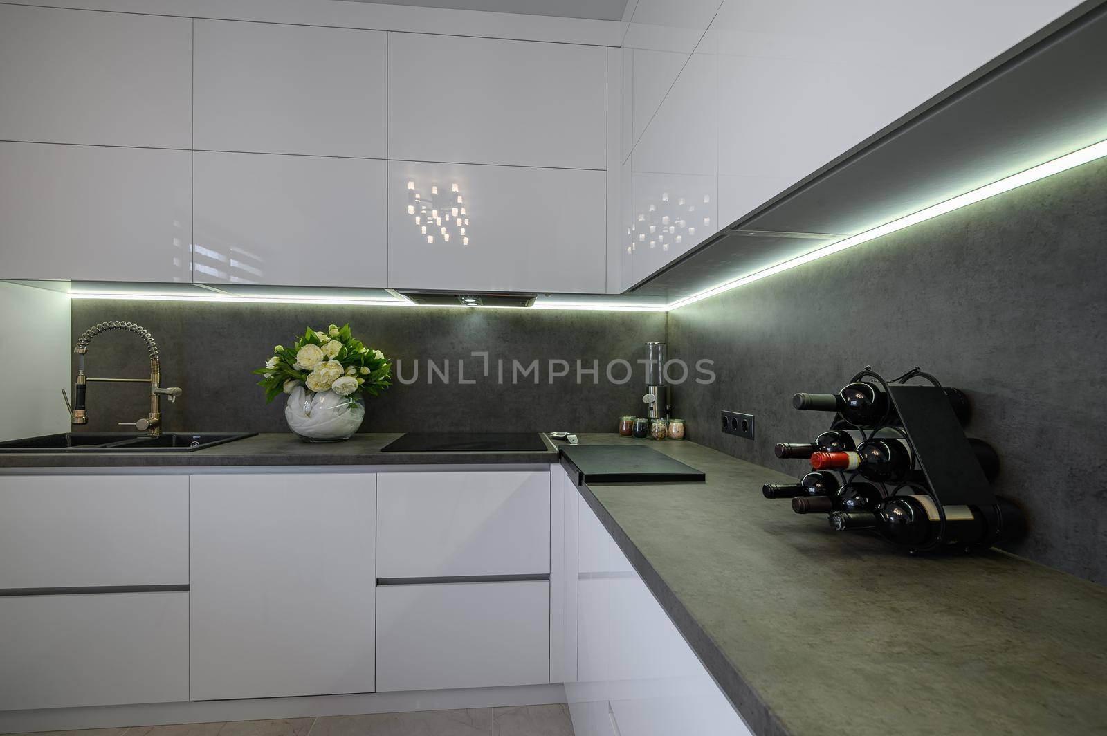 Closeup to dark grey stone counter work top at white trendy kitchen