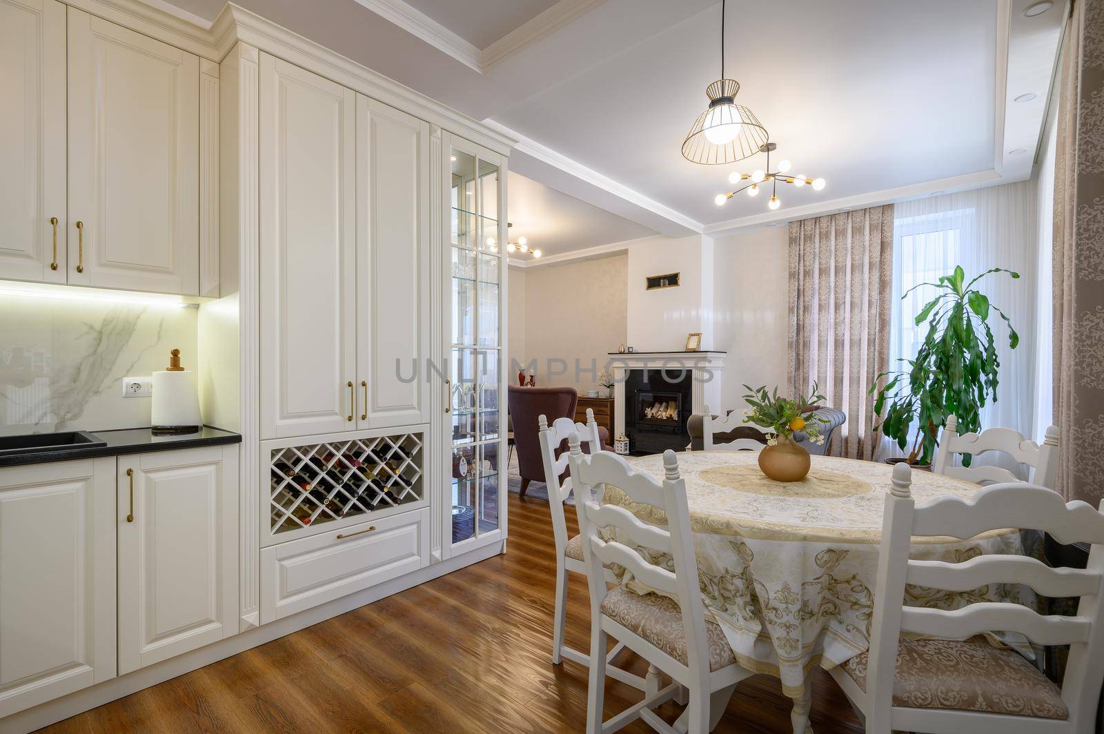 Modern classic large white colored luxurious kitchen and dining room in studio apartment interior