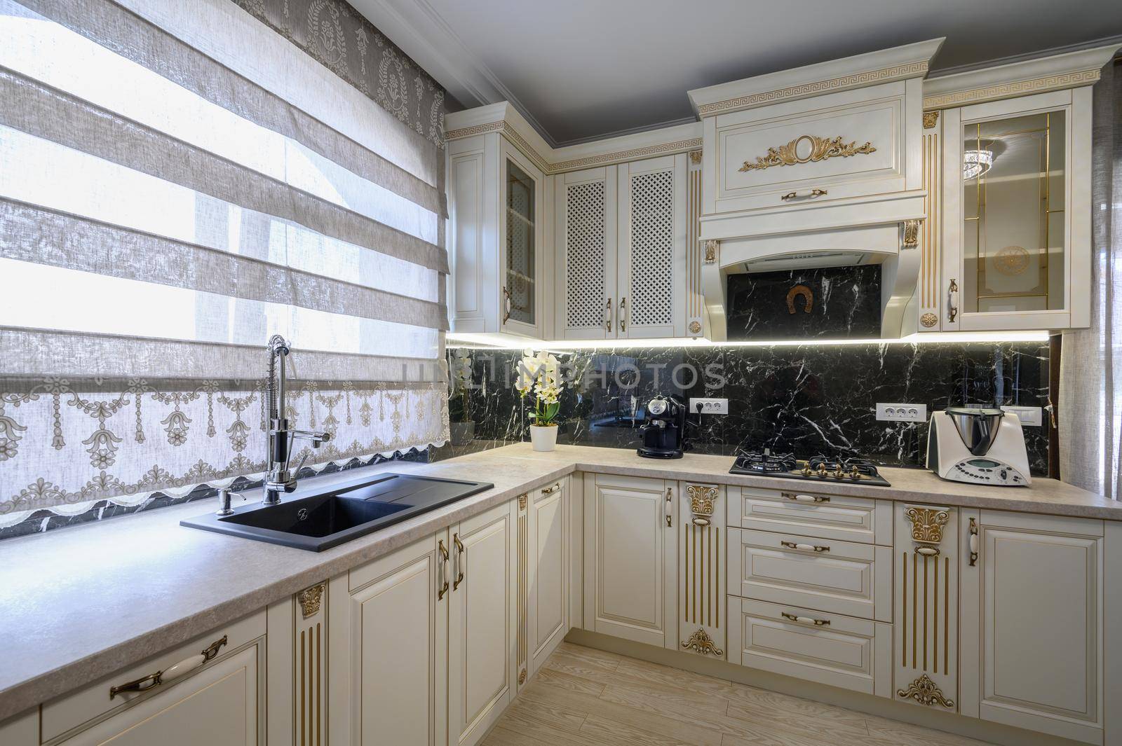 White rich classic cozy kitchen and dining room in city house interior