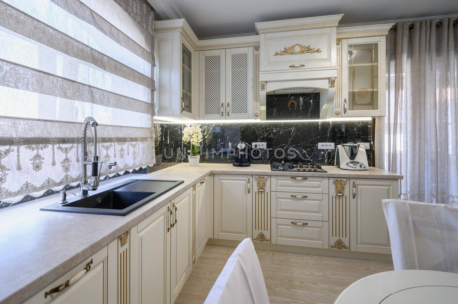 Modern classic white and beige luxurious kitchen with dining room in studio apartment interior