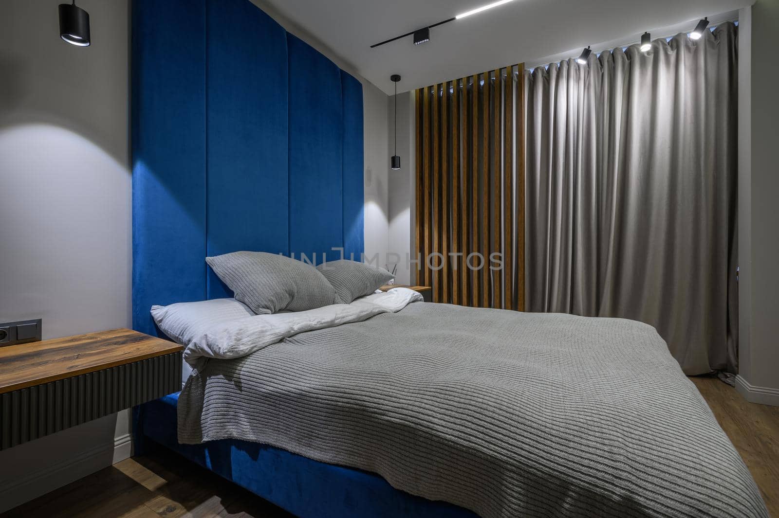 Cozy and luxury master bedroom in blue and grey colors with elegant and modern details