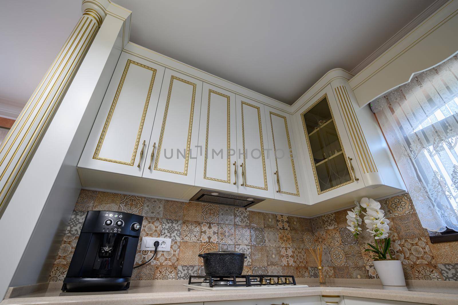White classic cozy kitchen and dining room in city house interior