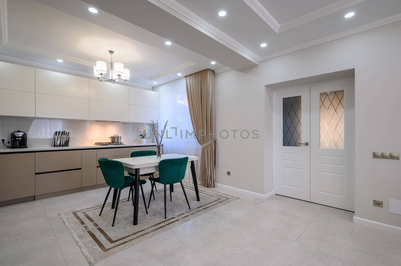 Modern classic white and beige luxurious kitchen with dining room in studio apartment interior