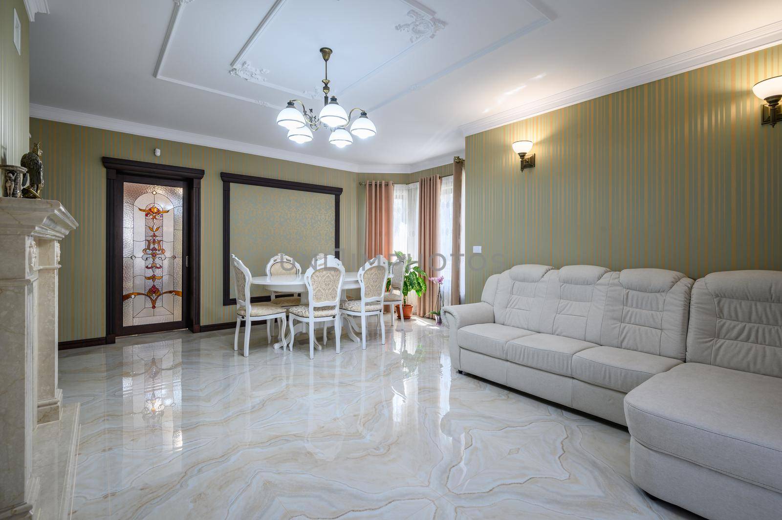 Classic living room interior design. Spacious room, luxury marble floor, table with elegant chairs and sofa