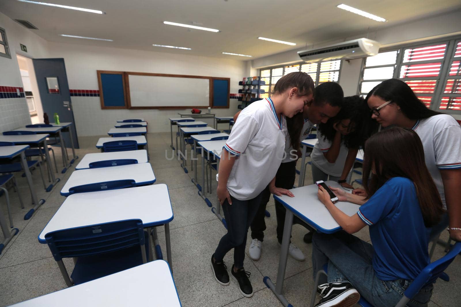santana, bahia, brazil - september 13, 2022: students using smartphones in a classroom of a full-time state public school in the city of Santana.
