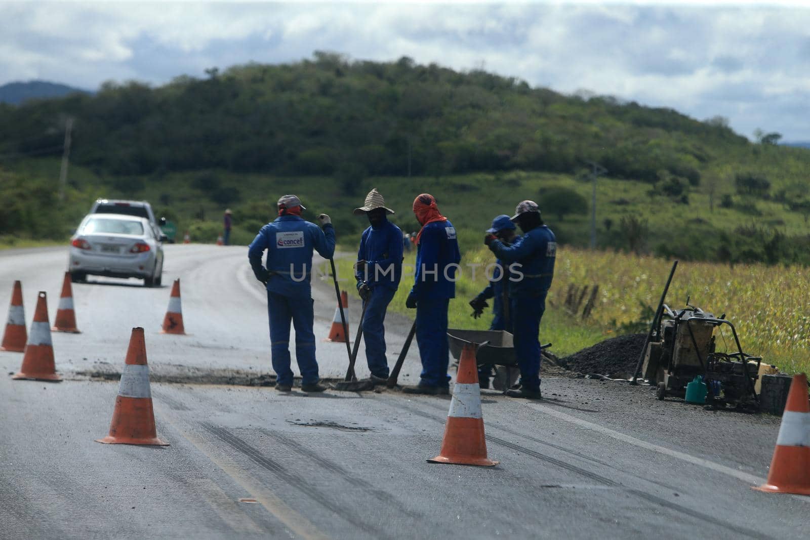 serra preta, bahia, brazil - september 13, 2022: workers recovering the BA 052 highway lane in the city of Serra Preta.