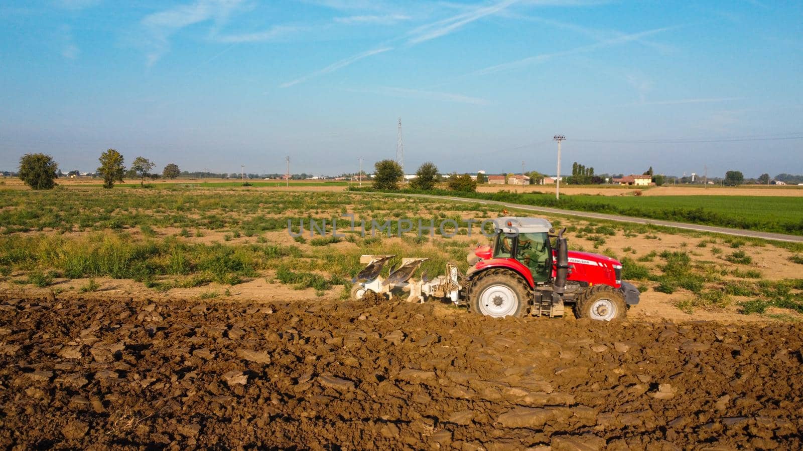 Aerial view with drone of tractor plowing the land in the countryside.