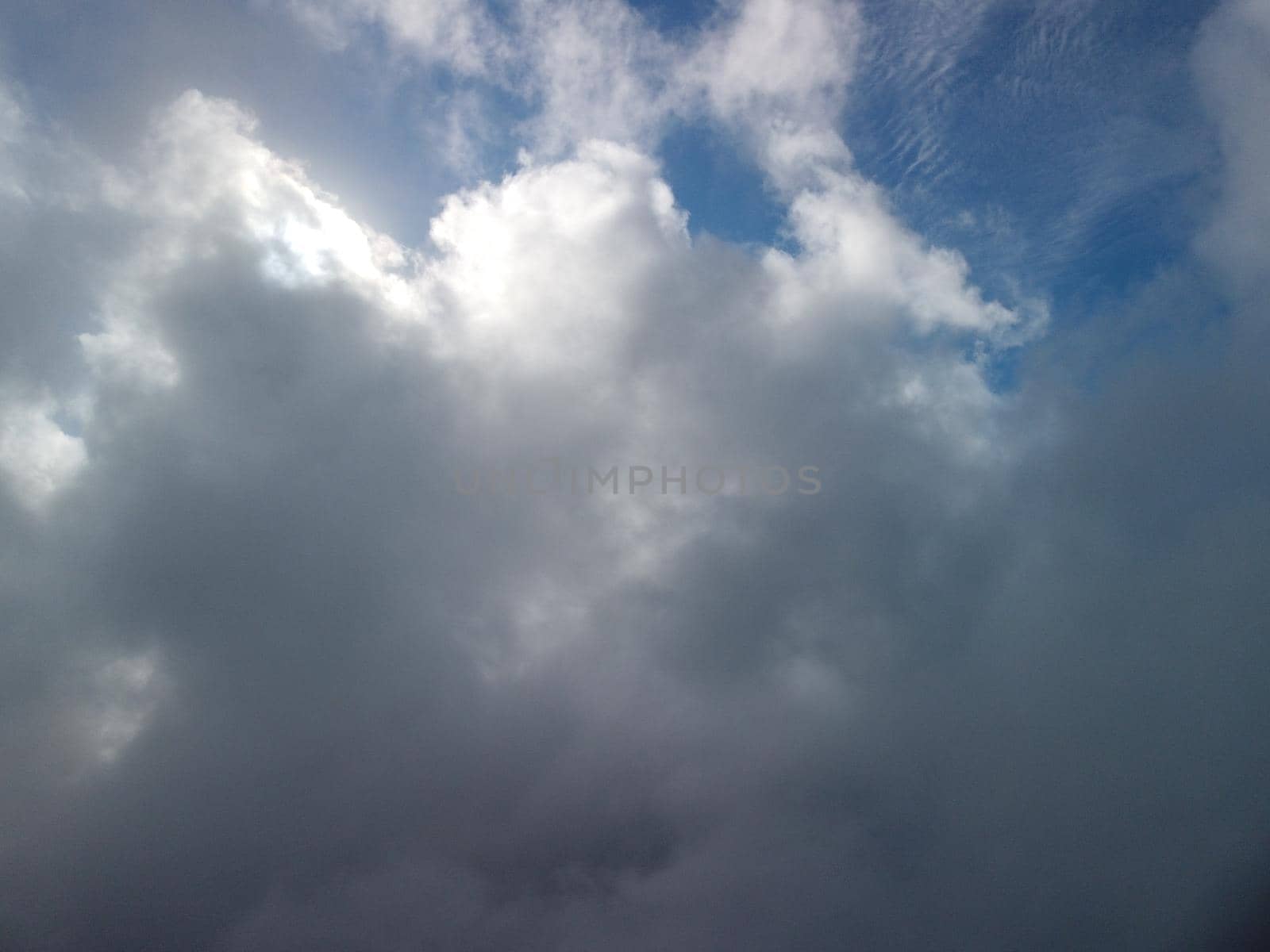 Aerial view drone flying above white clouds dense fog move quickly. Drone flies high back in blue sky through fluffy clouds. Beautiful foggy and cloudy slow moving Aerial view. Fog sea.