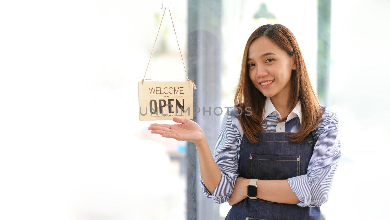 Startup successful small business owner sme beauty girl stand with tablet smartphone in coffee shop restaurant. Portrait of asian tan woman barista cafe owner. SME entrepreneur seller business concept.