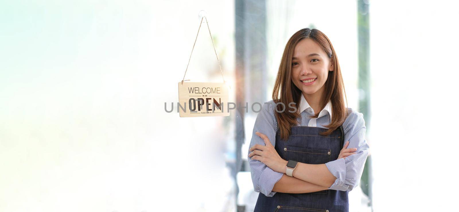 Startup successful small business owner sme beauty girl stand with tablet smartphone in coffee shop restaurant. Portrait of asian tan woman barista cafe owner. SME entrepreneur seller business concept.