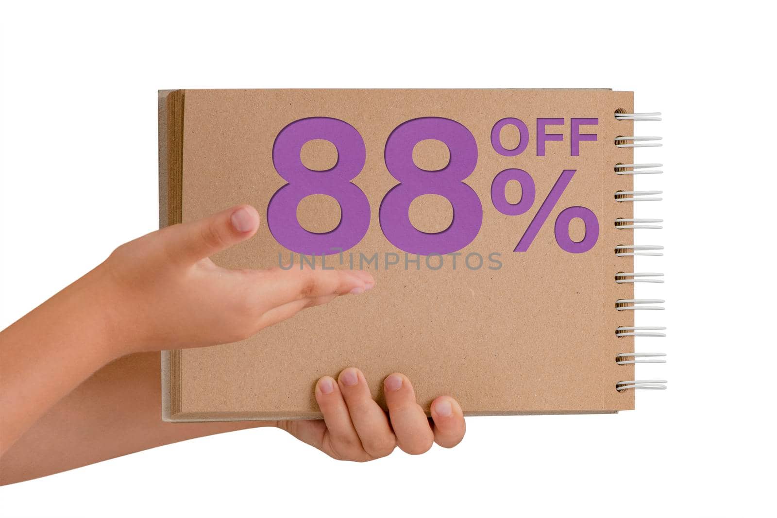 88 percent discount on isolate. Notepad from recycled paper in the hands of a child with text, sale up to 88 percent. The child is holding a notepad demonstrating a big sale