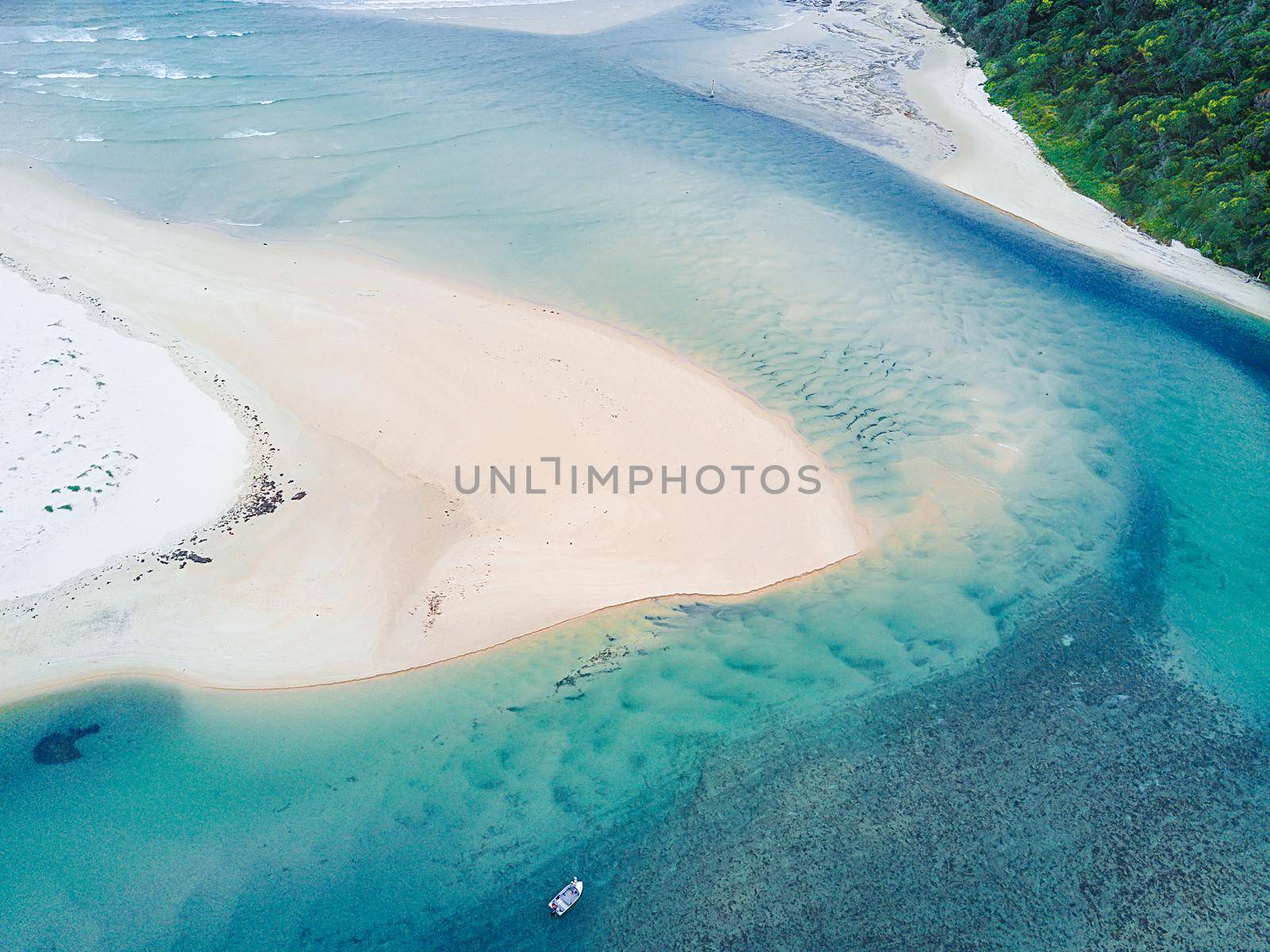 Aerial view of coastal inlet with sand bar and patterns by lovleah