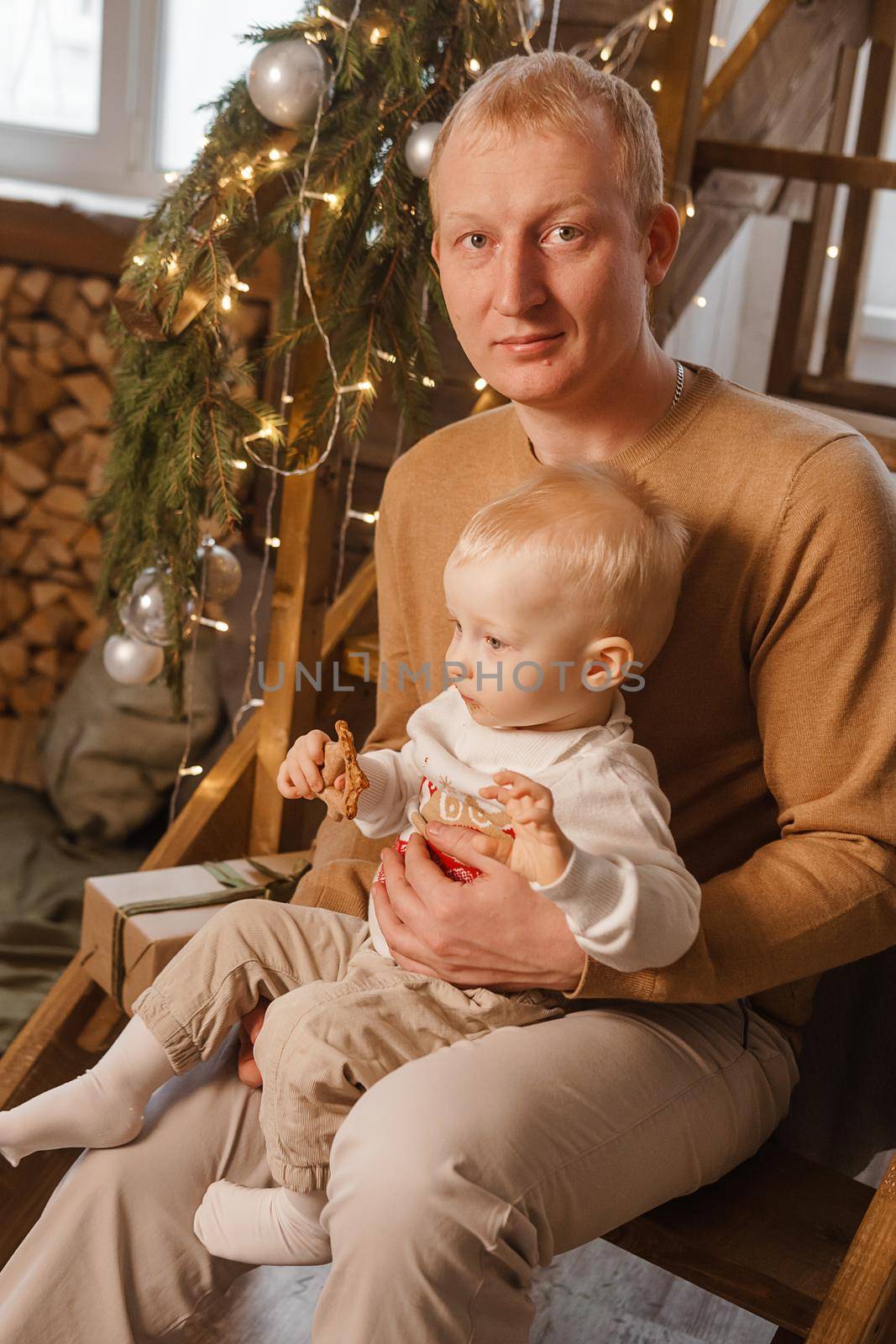 Dad and his little son in a magical Christmas atmosphere. The concept of family relations and New Year celebrations