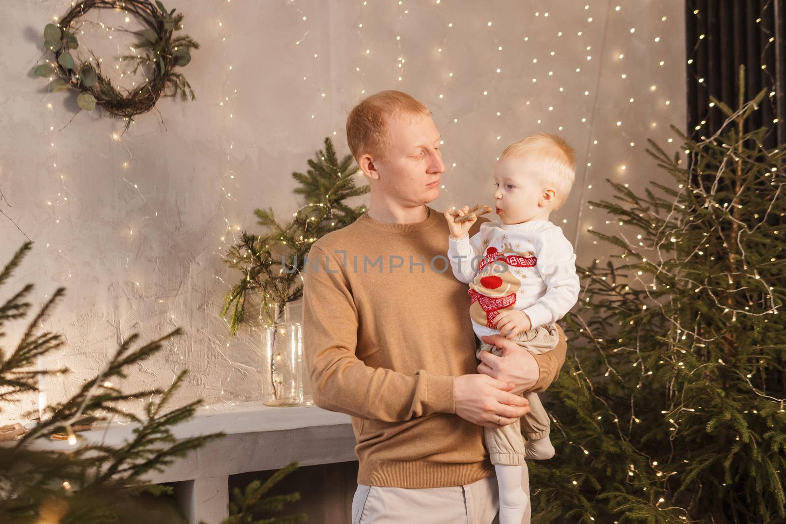 Dad and his little son in a magical Christmas atmosphere. The concept of family relations and New Year celebrations.