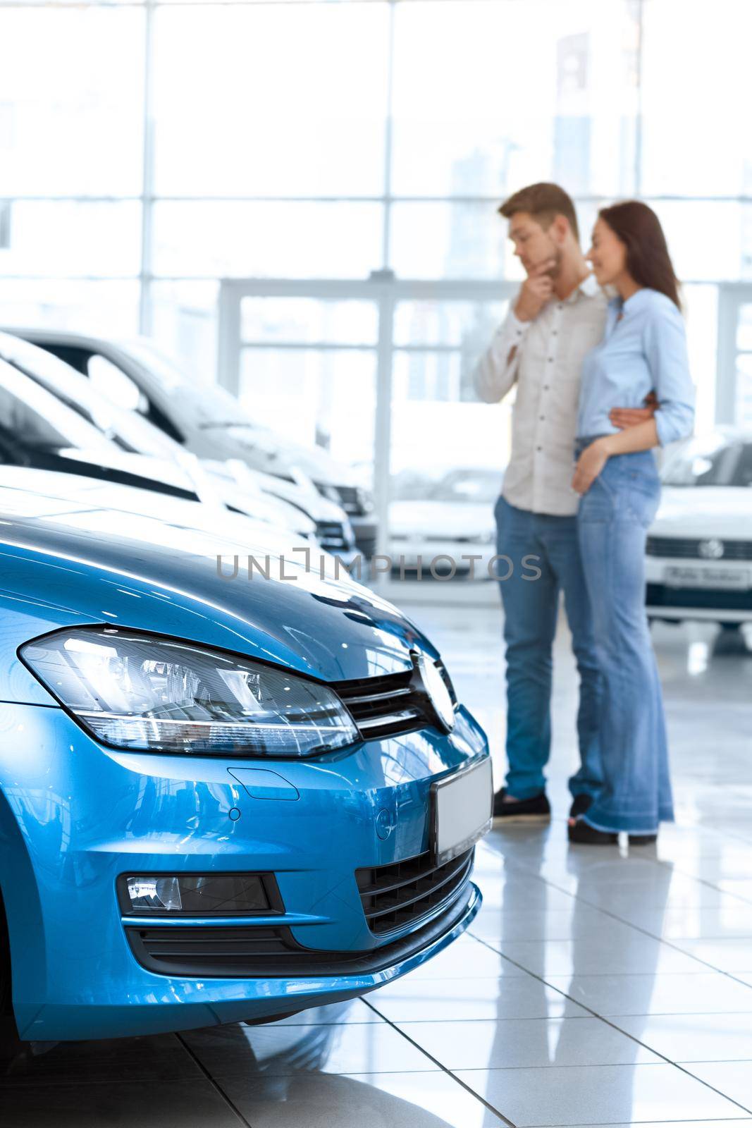 Couple choosing a car at the car salon by MAD_Production