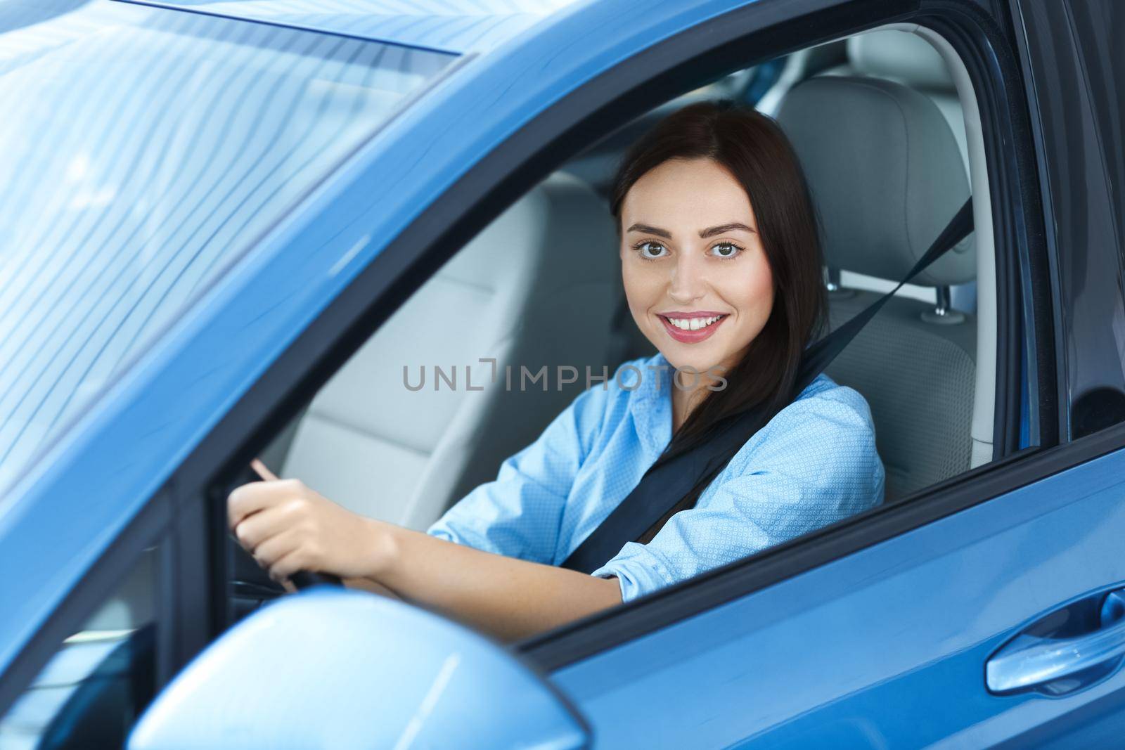 Beautiful woman sitting in a car by MAD_Production