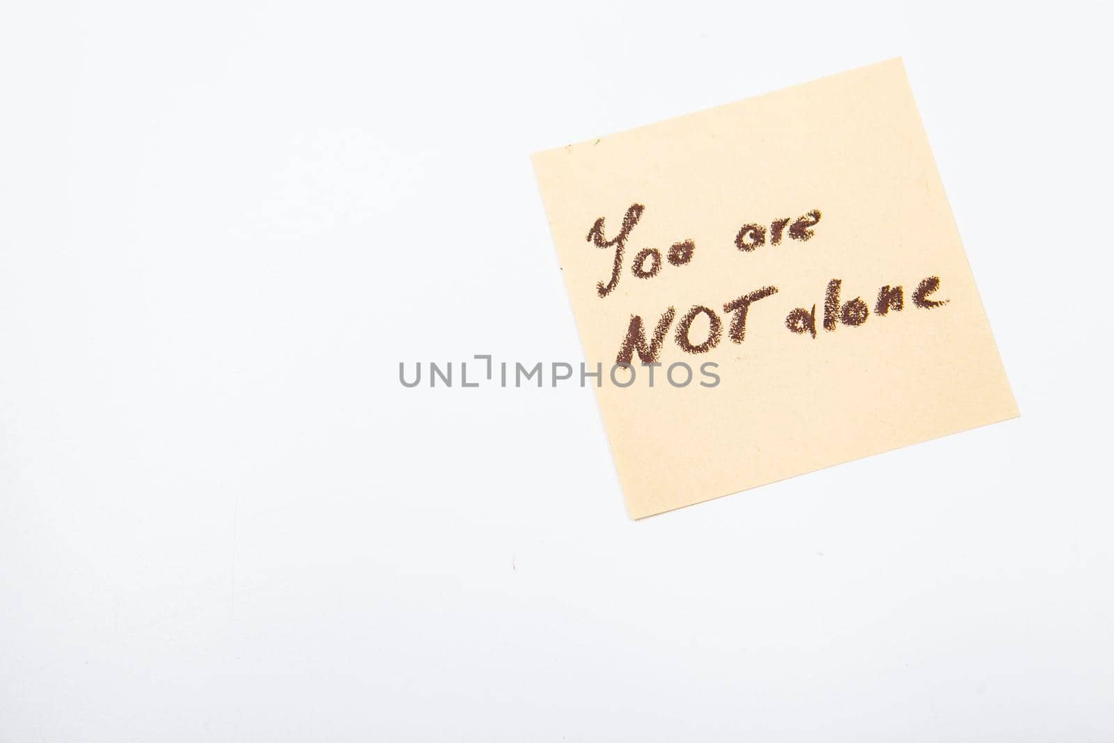 You are not alone inspirational note on yellow sticker memo
