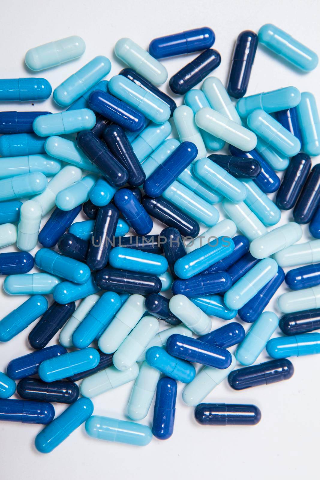 Many capsules pills on white background by MAD_Production